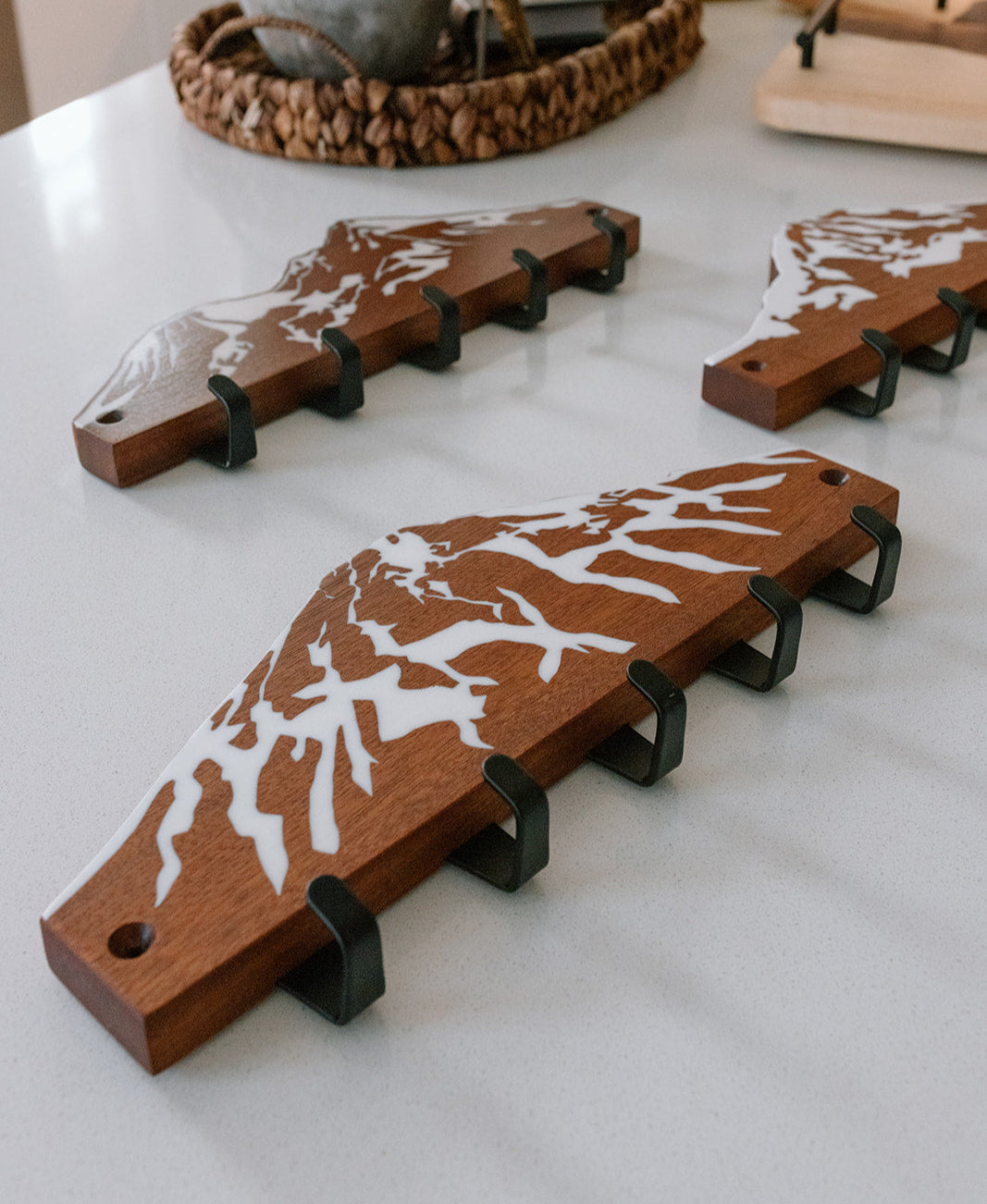 Wooden key holders arranged on a counter.