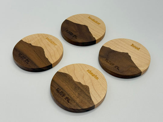 Four wooden coasters on a white background.