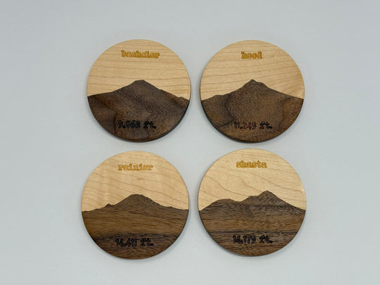 Four wooden coasters on a white background.