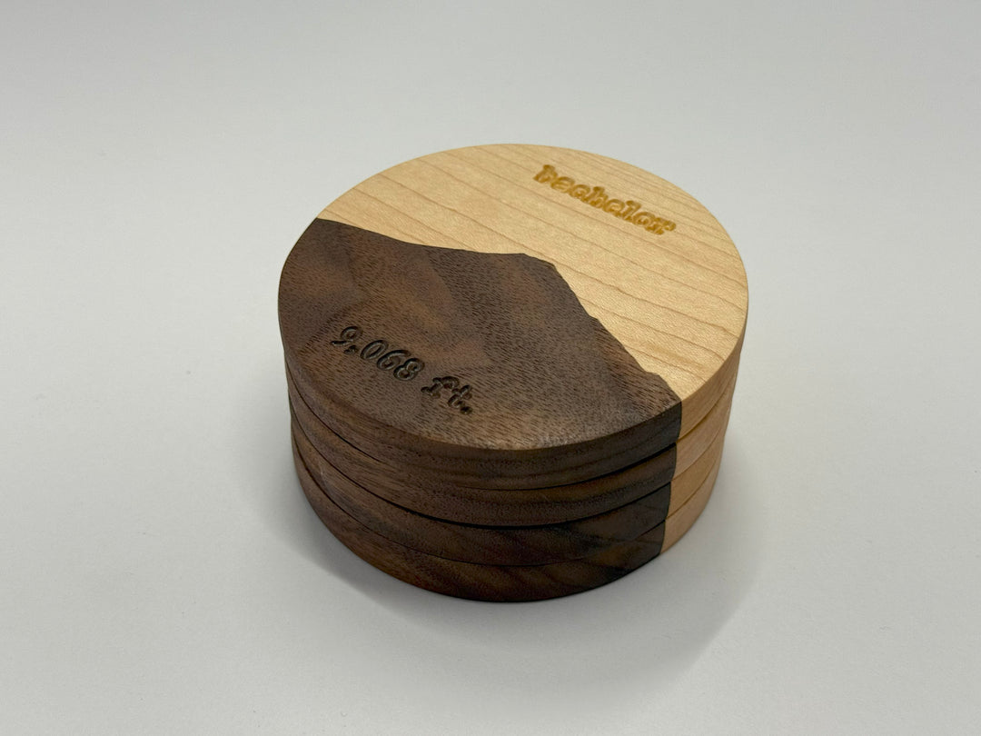 Four wooden coasters on a white background.