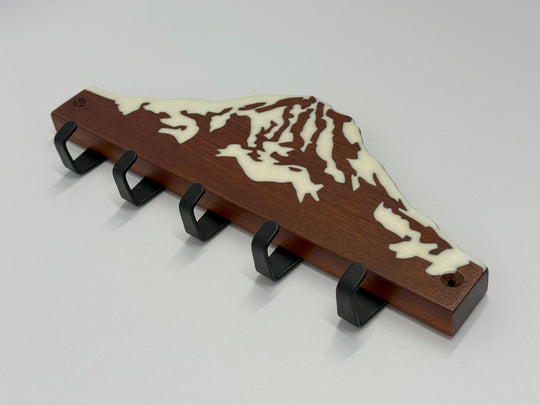 A wooden keyholder on a white background.